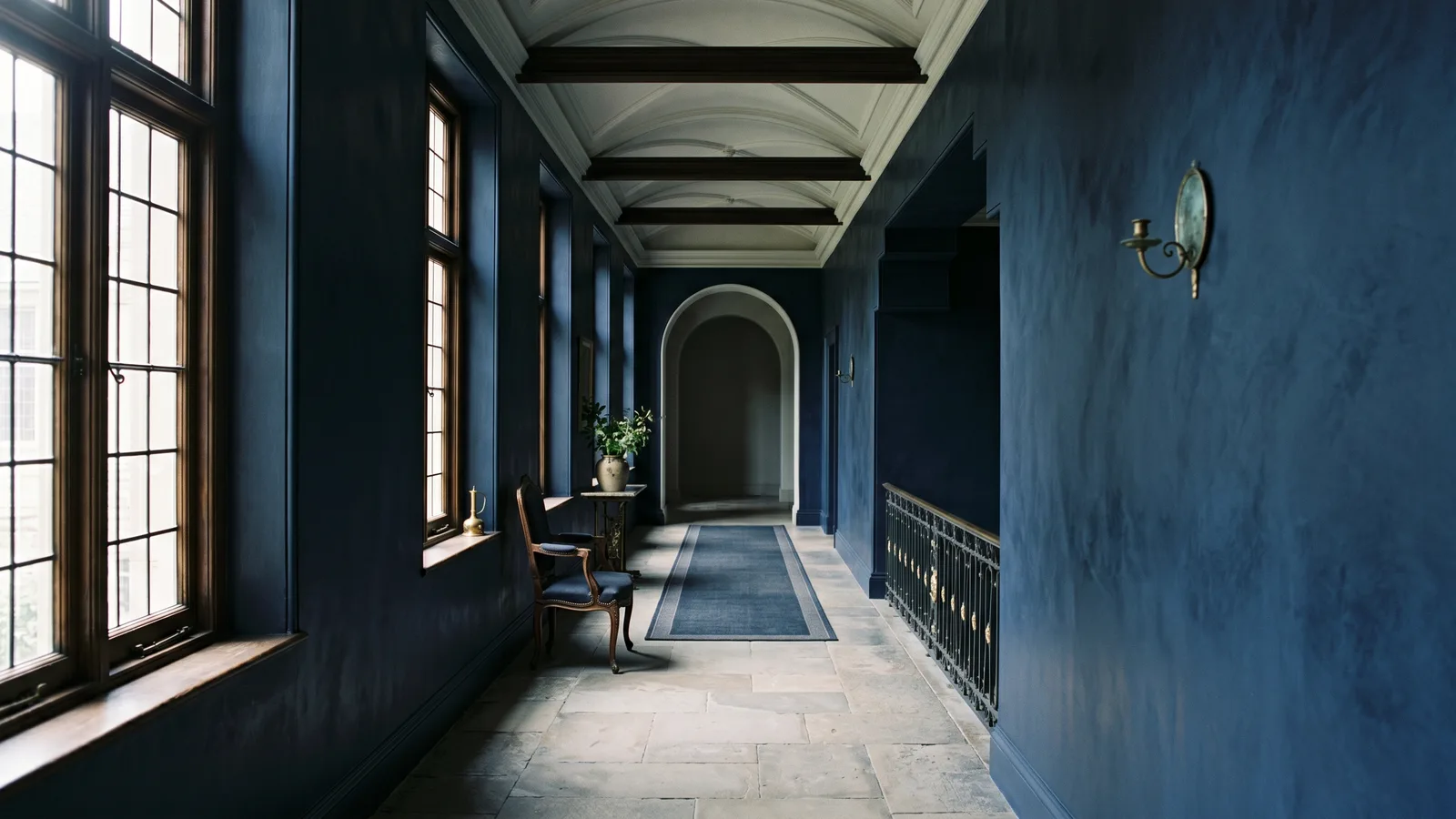 Soft light entering a quiet hallway through tall windows