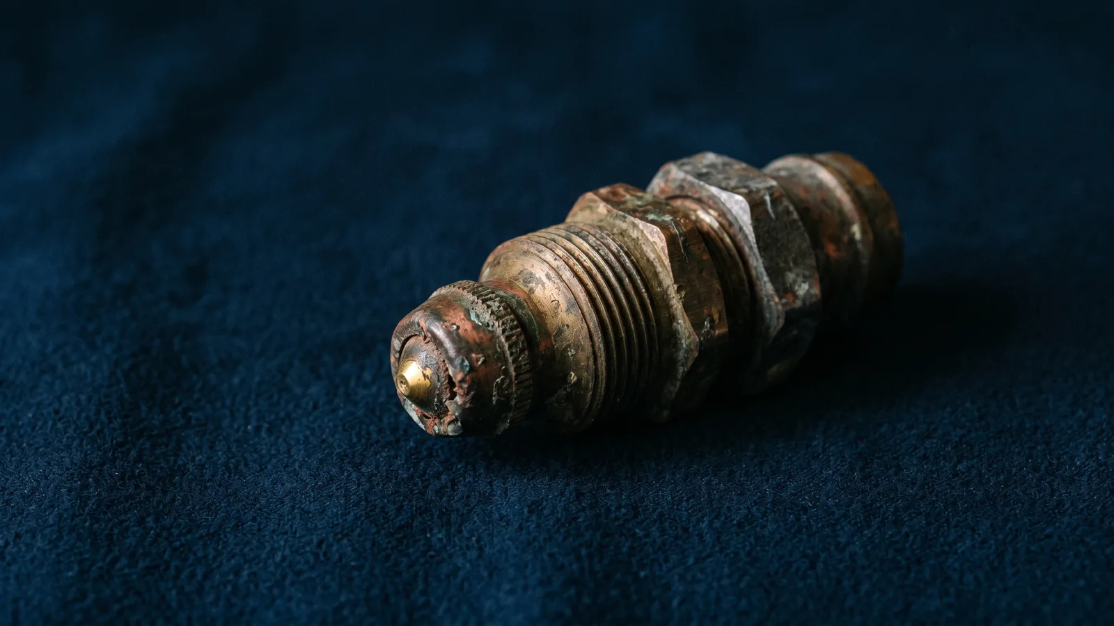 A weathered agricultural sprayer nozzle, industrial still life