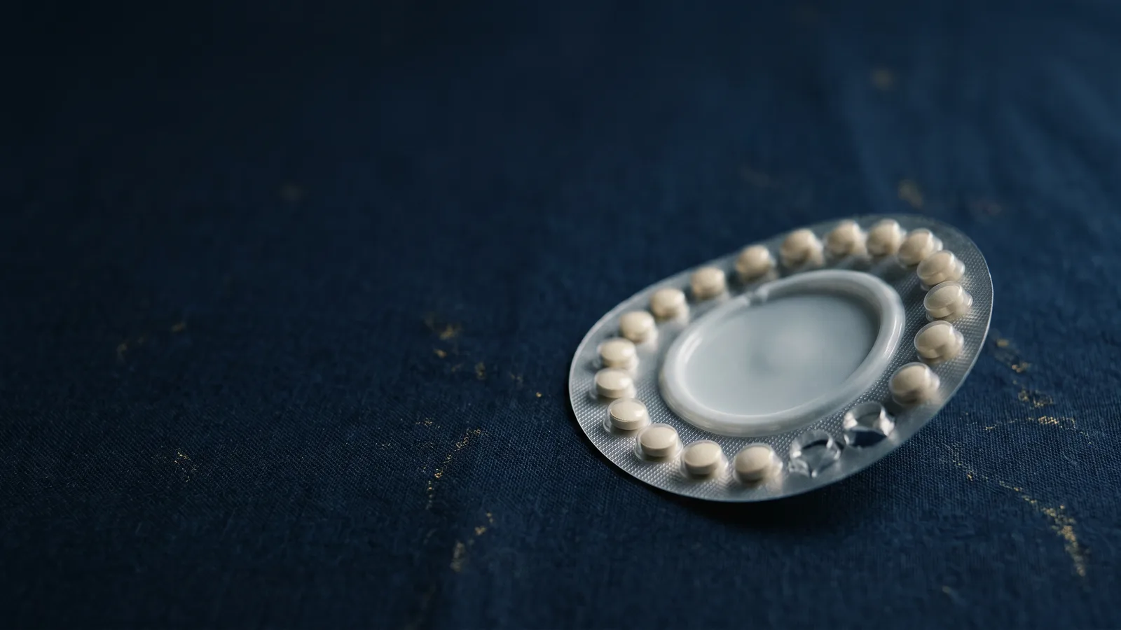 A circular birth-control blister pack at a steep angle